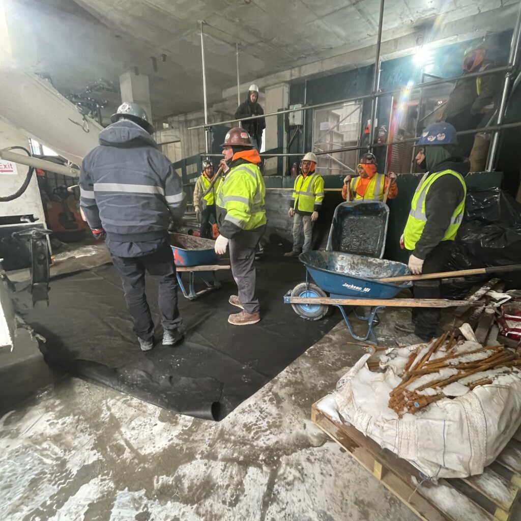 Workers from Andrew Horan Alba learning controlled demolition techniques during training session.