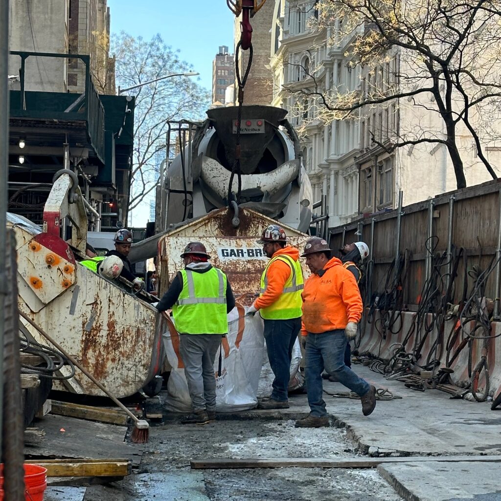 Andrew Horan Alba overseeing NYC construction site operations with modern equipment and safety protocols
