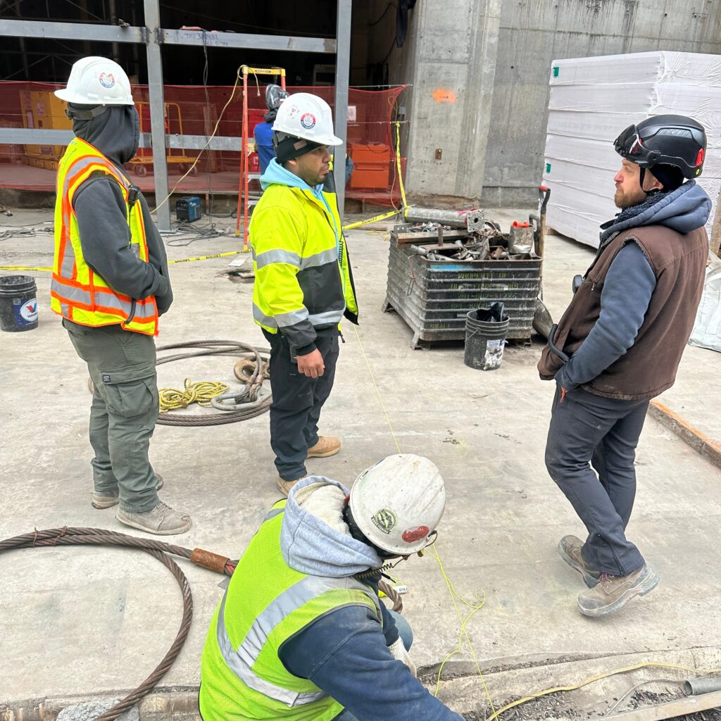 Andrew Horan Alba overseeing NYC construction site operations with modern equipment and safety protocols