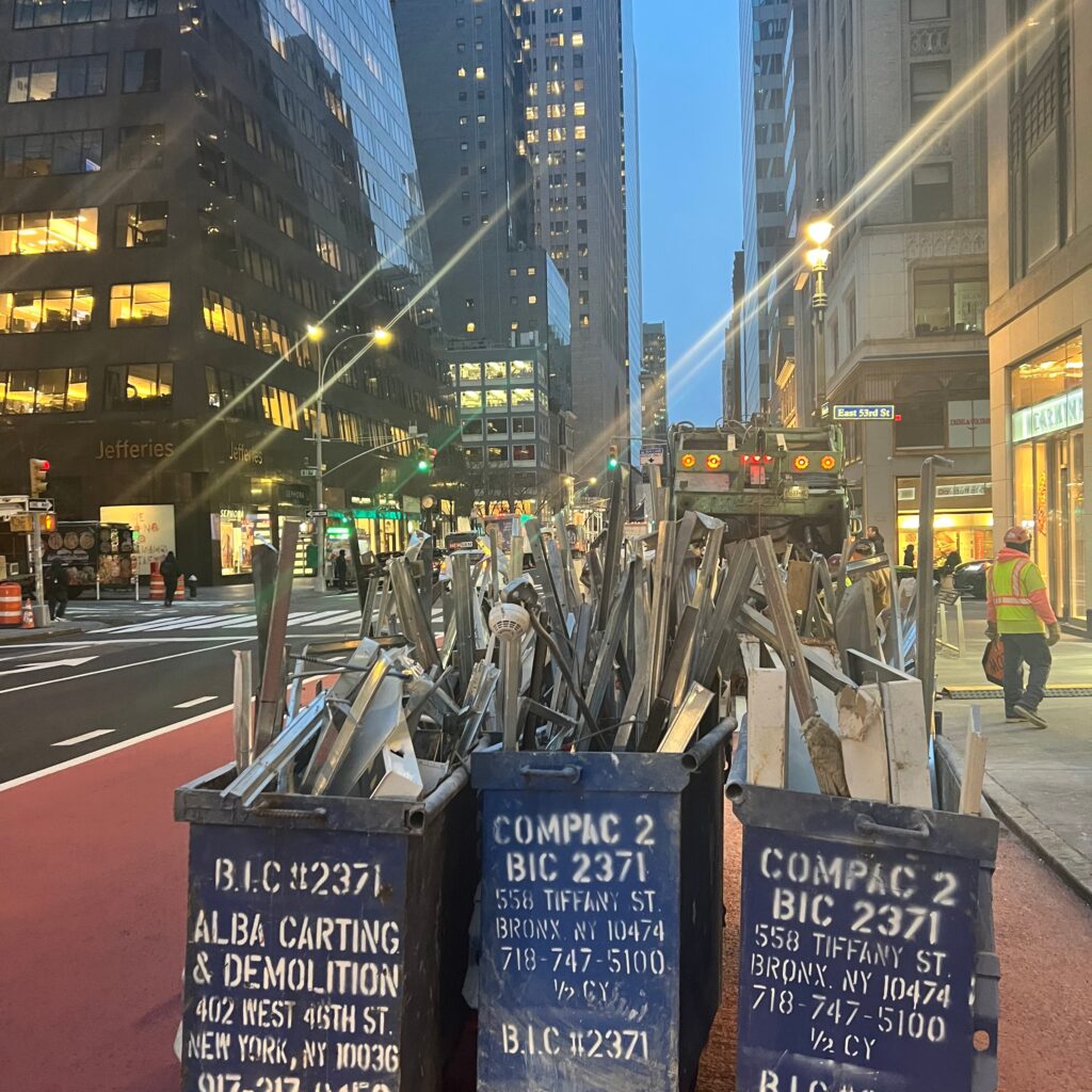Andrew Horan Alba guiding a construction and demolition team on a New York City job site with skyscrapers in the background.