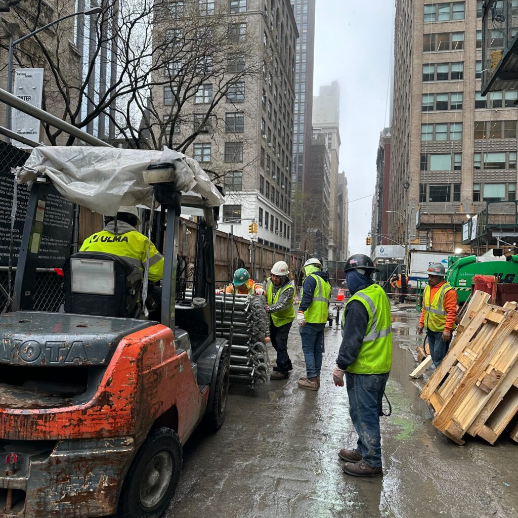 “Andrew Horan Alba managing a New York City demolition and construction site with professional crews and modern safety equipment.”